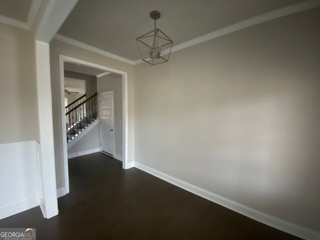 unfurnished dining area with stairs, ornamental molding, ceiling fan with notable chandelier, and baseboards