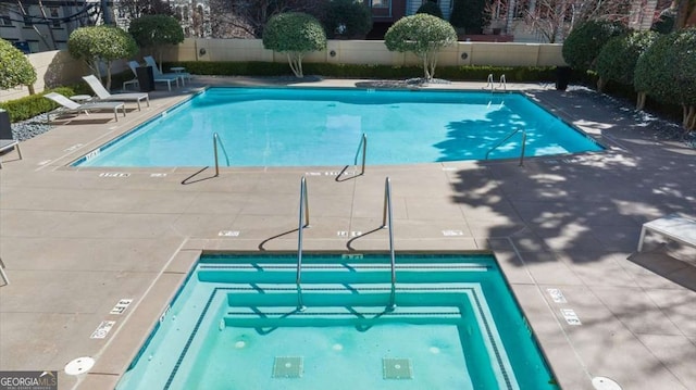 pool featuring fence and a patio