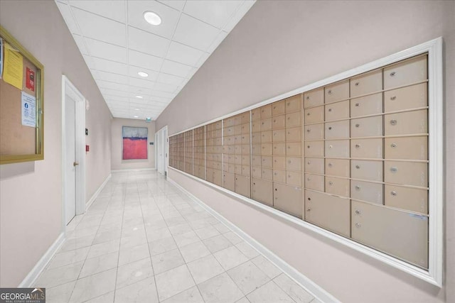 corridor with tile patterned flooring, a paneled ceiling, recessed lighting, baseboards, and mail area