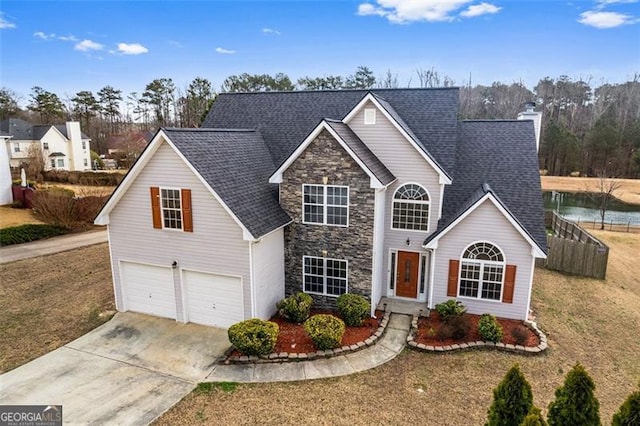 traditional-style home featuring an attached garage, a shingled roof, stone siding, concrete driveway, and a chimney