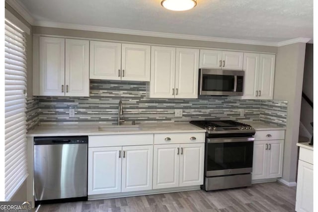 kitchen featuring light countertops, appliances with stainless steel finishes, and a sink