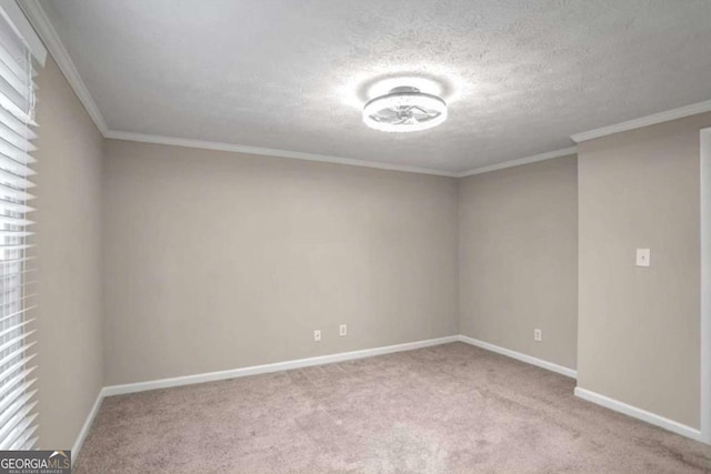 unfurnished room featuring carpet floors, a textured ceiling, baseboards, and crown molding