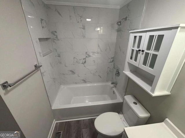 bathroom with shower / washtub combination, visible vents, toilet, vanity, and wood finished floors