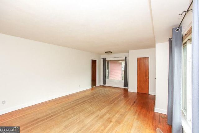 unfurnished room featuring light wood-style floors and baseboards