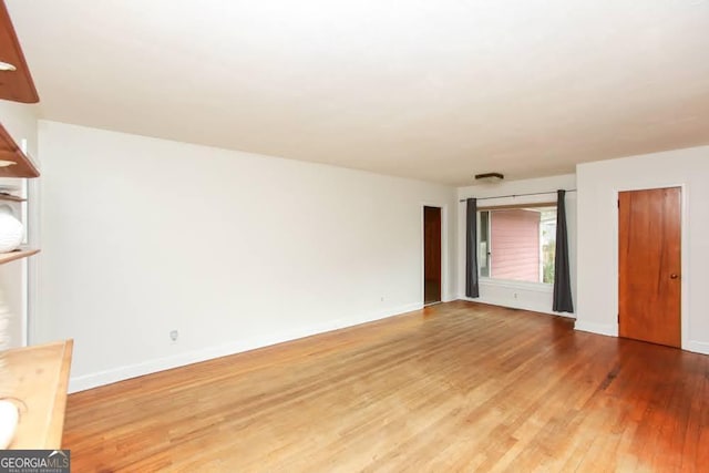 interior space featuring wood finished floors and baseboards