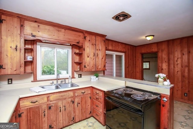 kitchen with black electric range, light floors, open shelves, light countertops, and a sink