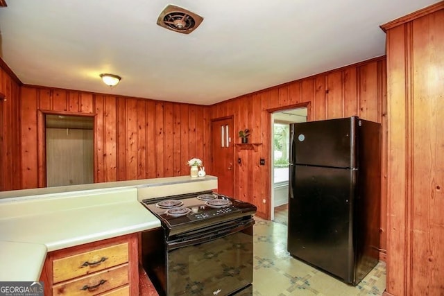 kitchen with black appliances, brown cabinetry, light floors, and light countertops