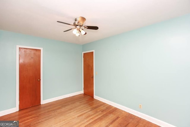 unfurnished bedroom with baseboards, a closet, and light wood-style floors