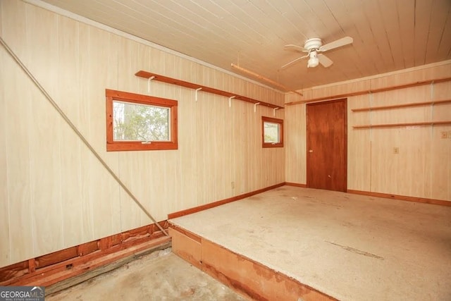 basement featuring a ceiling fan and wood ceiling