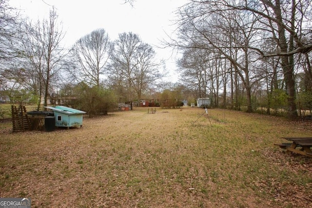 view of yard featuring an outbuilding and a storage unit