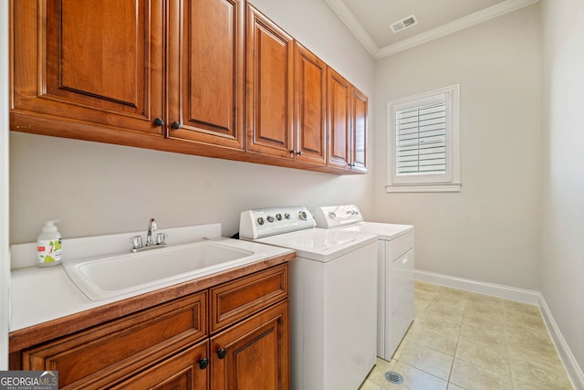 washroom with cabinet space, visible vents, ornamental molding, a sink, and washer and dryer