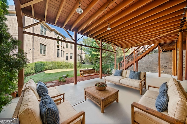 view of patio / terrace featuring an outdoor living space and stairway