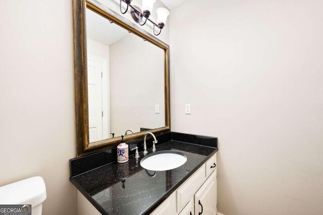 half bathroom featuring toilet and vanity