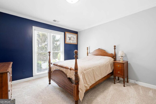 carpeted bedroom with visible vents, baseboards, and ornamental molding