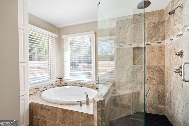 full bathroom with tiled shower and a garden tub