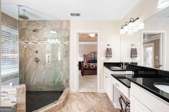 full bathroom featuring a tile shower, a sink, and double vanity