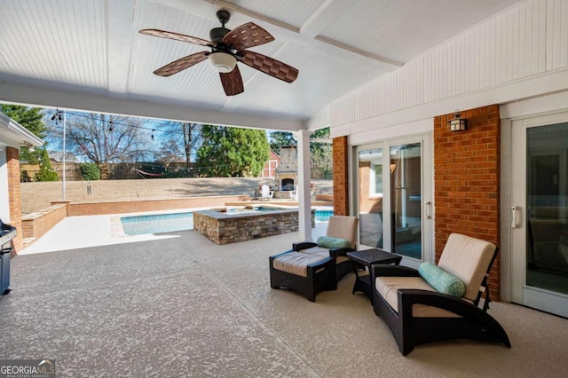 view of patio / terrace with a fenced in pool and a ceiling fan