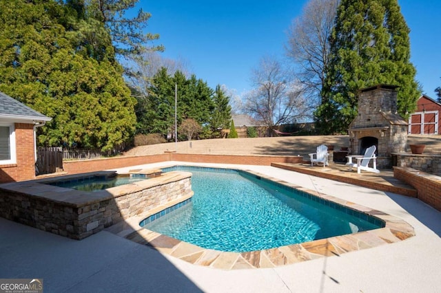 view of swimming pool with fence, an outdoor stone fireplace, a fenced in pool, an in ground hot tub, and a patio area