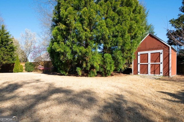 view of yard with a storage shed and an outbuilding