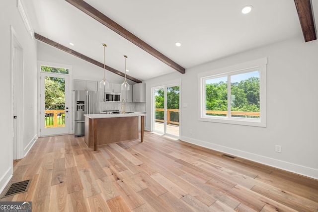 6564 Bermuda Ln, Flowery Branch, GA 30542 - kitchen with stainless steel appliances, light countertops, baseboards, an island with sink, and recessed lighting