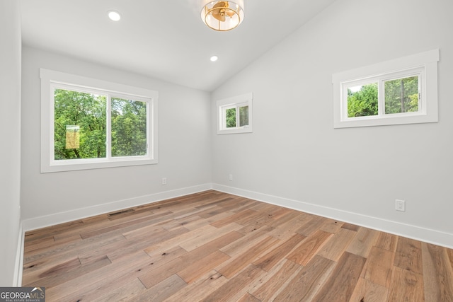 6564 Bermuda Ln, Flowery Branch, GA 30542 - spare room featuring baseboards, lofted ceiling, light wood-type flooring, and recessed lighting