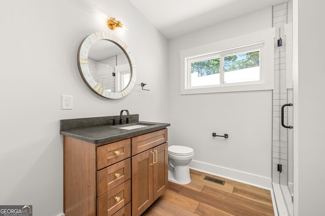 6564 Bermuda Ln, Flowery Branch, GA 30542 - full bath with vanity, wood finished floors, toilet, and a stall shower