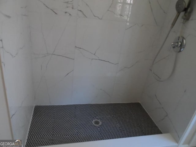 bathroom with a marble finish shower