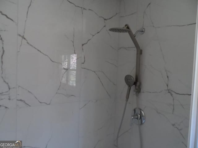 details featuring a marble finish shower