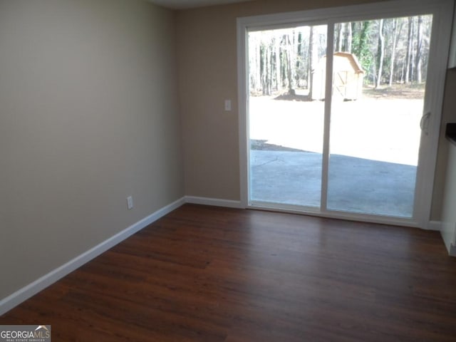 entryway with baseboards and dark wood finished floors