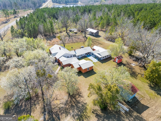 birds eye view of property with a wooded view