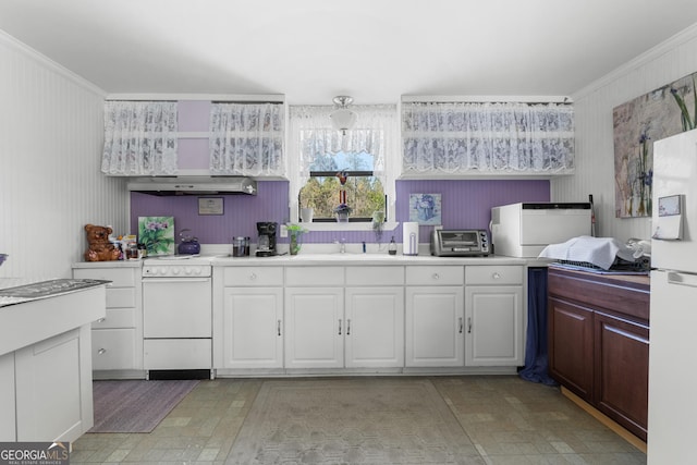 kitchen with white appliances, white cabinetry, light countertops, and crown molding