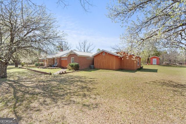 view of home's exterior with a storage shed, an outdoor structure, and a lawn