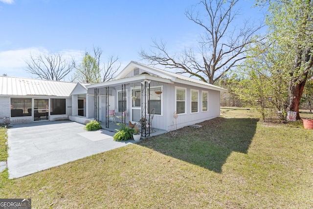 view of front of house featuring a front lawn and a sunroom