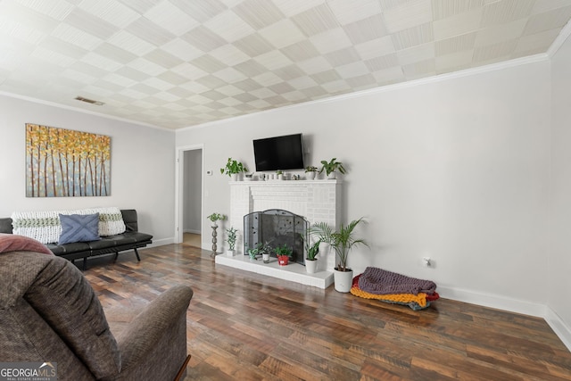 living room featuring a fireplace, wood finished floors, baseboards, and ornamental molding