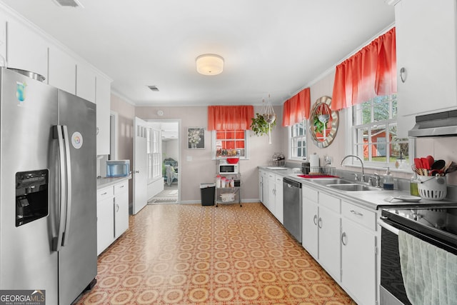 kitchen with extractor fan, light countertops, appliances with stainless steel finishes, white cabinetry, and a sink