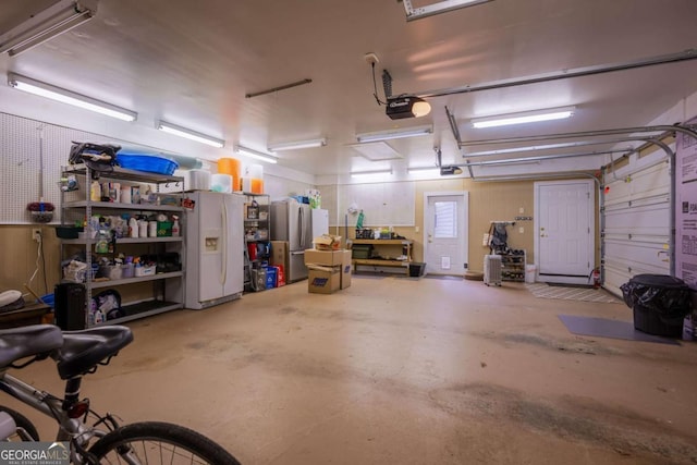 132 Sanderlin Mountain Dr S, Big Canoe, GA 30143 - garage with white refrigerator with ice dispenser, a garage door opener, and freestanding refrigerator