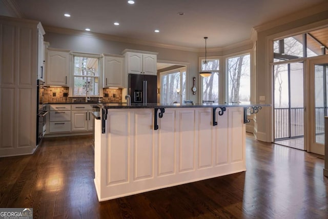 132 Sanderlin Mountain Dr S, Big Canoe, GA 30143 - kitchen with black fridge with ice dispenser, a kitchen bar, crown molding, dark wood-type flooring, and tasteful backsplash