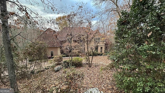 view of front of house with a tiled roof and stucco siding