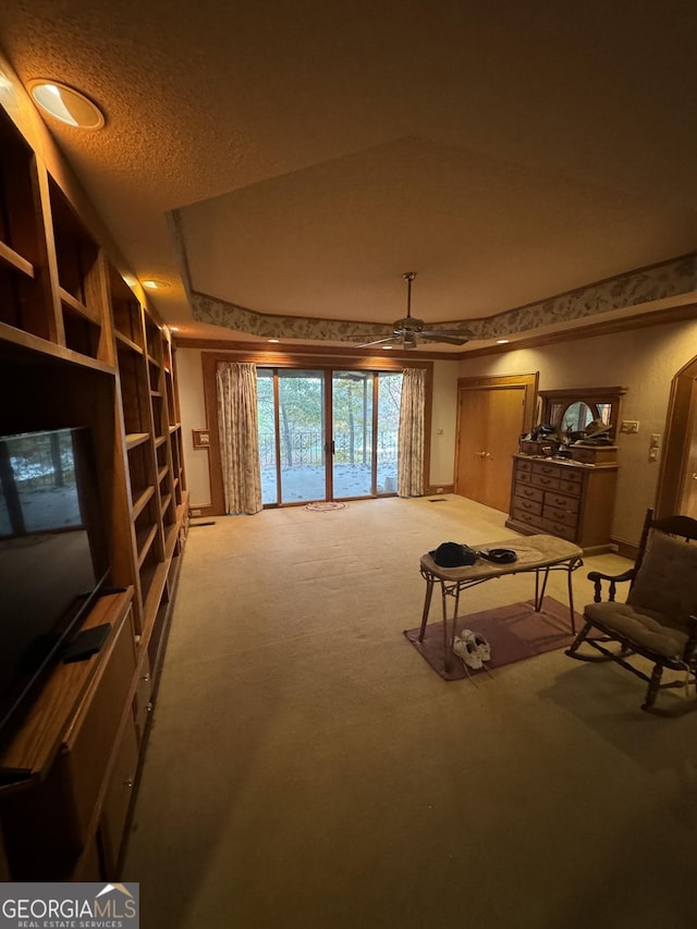 sitting room featuring carpet flooring and a textured ceiling