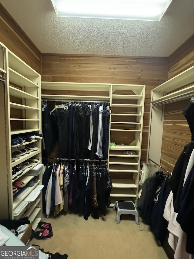 walk in closet with carpet floors