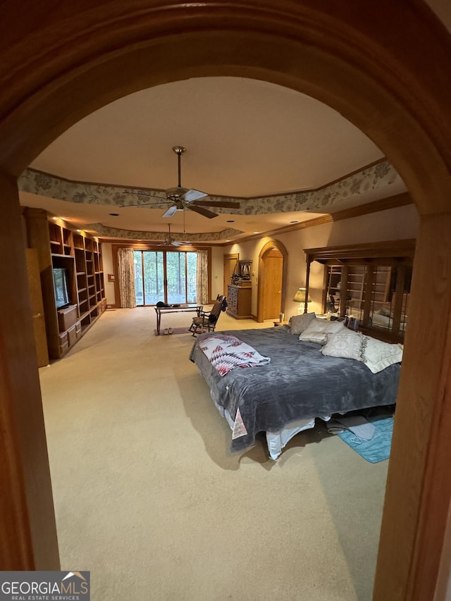 carpeted bedroom with arched walkways and vaulted ceiling