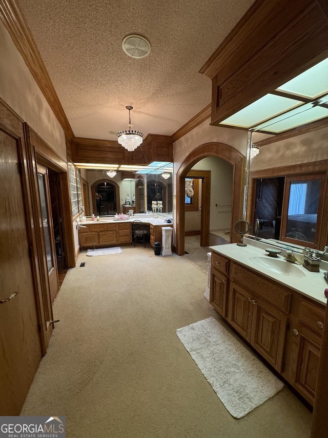 full bathroom with ornamental molding, carpet flooring, a textured ceiling, and vanity