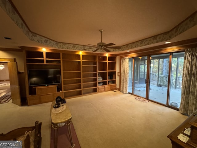 unfurnished living room with ceiling fan and carpet floors