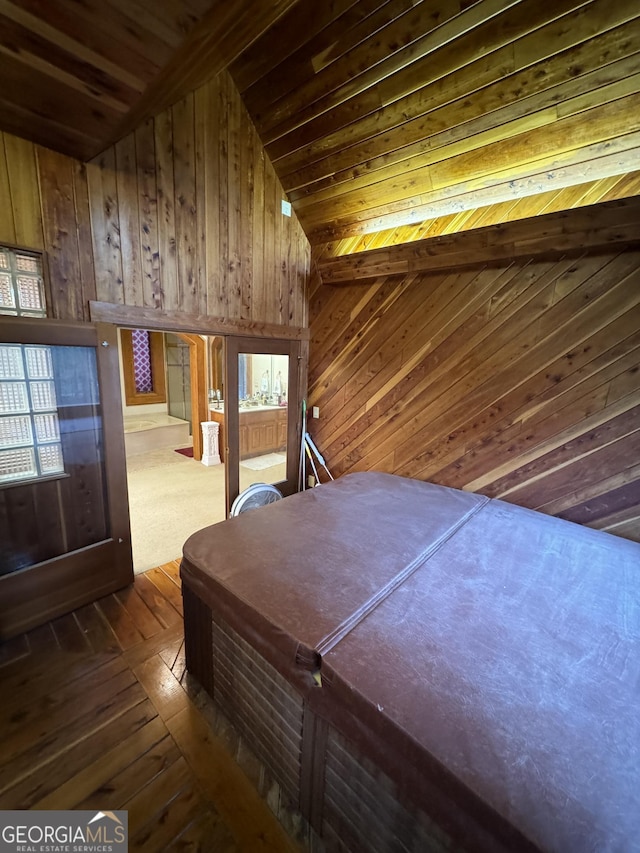 unfurnished bedroom featuring wooden ceiling, wood walls, and vaulted ceiling