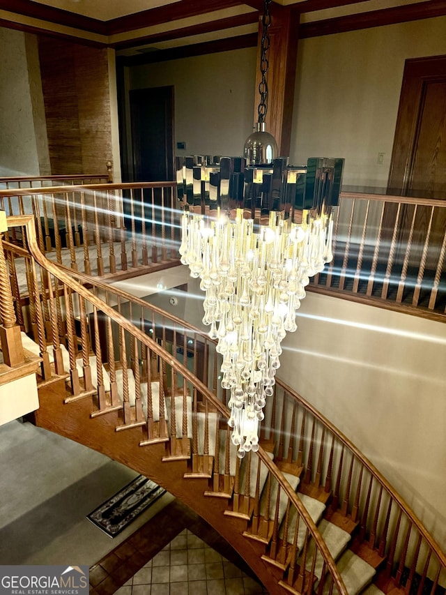 stairway with a chandelier and tile patterned flooring