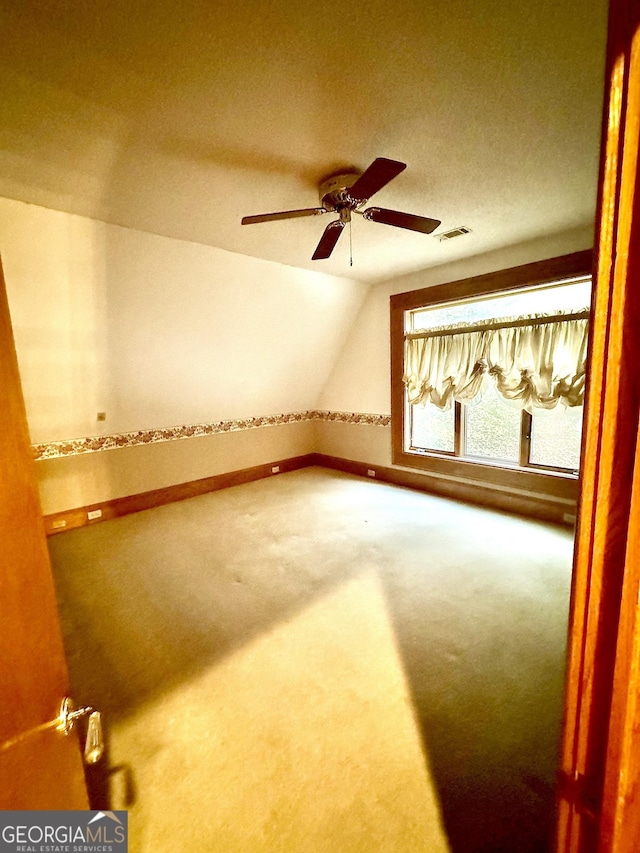 bonus room featuring ceiling fan, carpet, visible vents, and vaulted ceiling