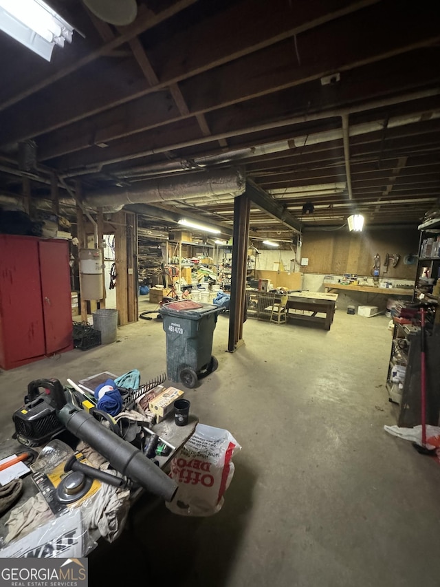 unfinished basement featuring a workshop area