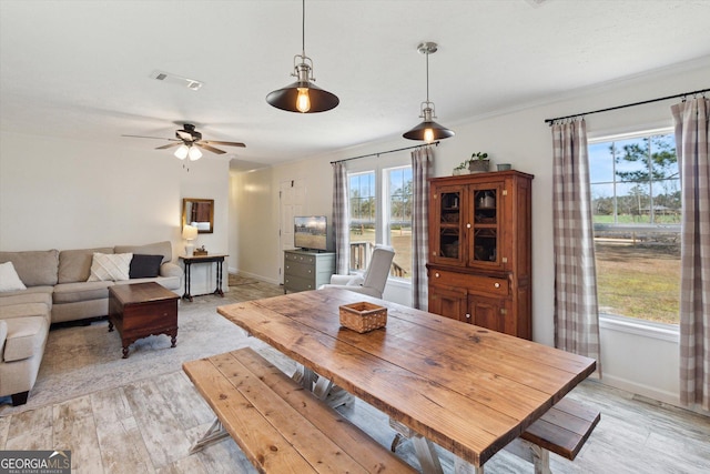 dining room with light wood-style flooring, baseboards, and visible vents