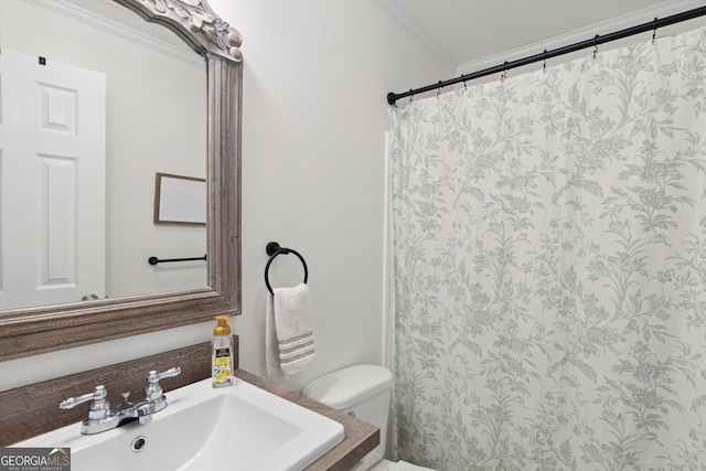 bathroom with a shower with shower curtain, vanity, toilet, and crown molding