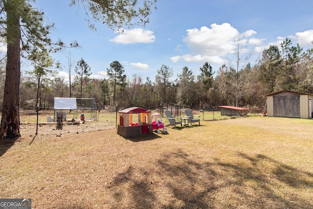 view of yard featuring a shed and an outdoor structure